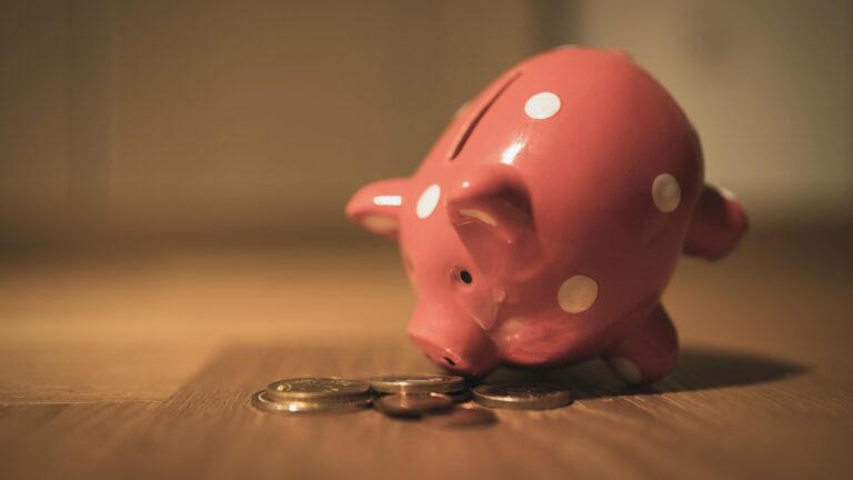 Tipped over piggy bank representing the costs of RV ownership