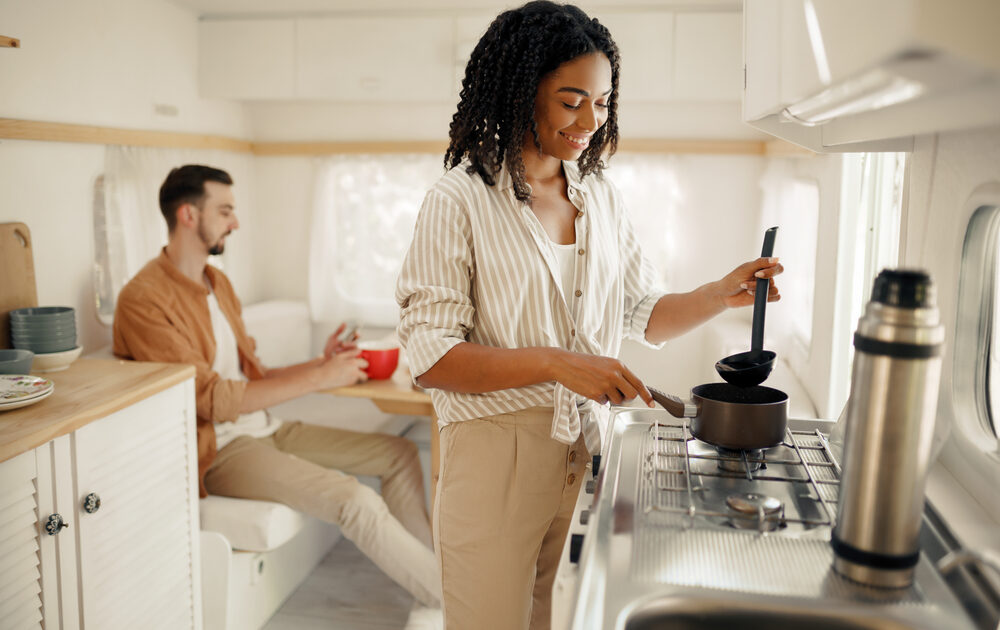 couple cooking in rv kitchen