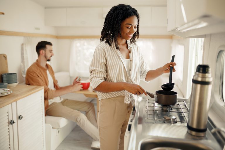 couple cooking in rv kitchen