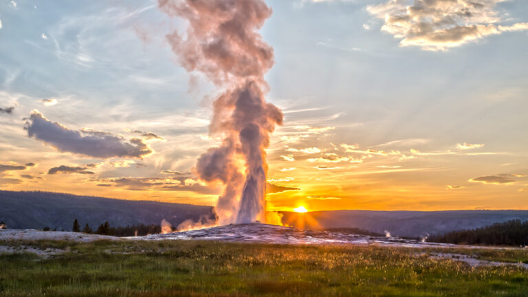 Old Faithful Geyser Eruption in Yellowstone National Park at Sunset