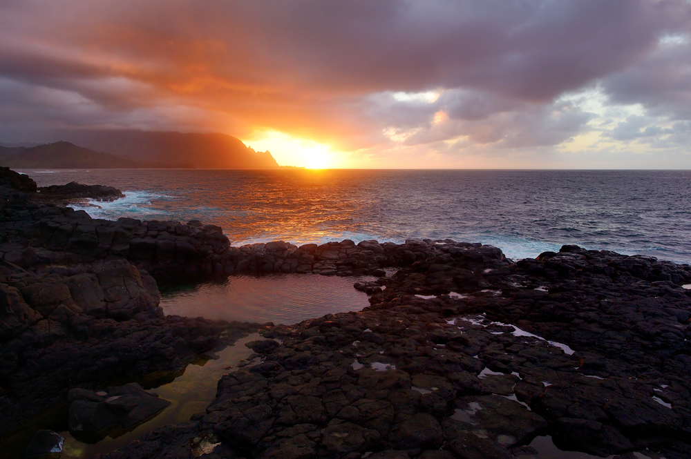 Queen's Bath on sunset on the island of Kauai, Hawaii. The pools are sinkholes surrounded by lava rock.