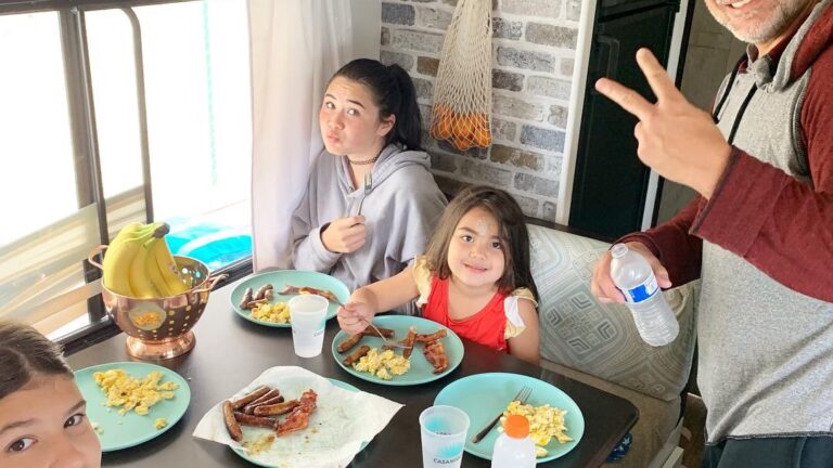 family enjoying breakfast in an RV kitchen