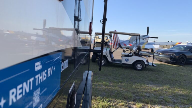 rv parked next to a golf cart
