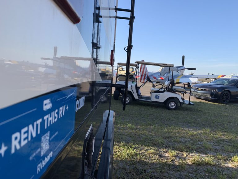 rv parked next to a golf cart