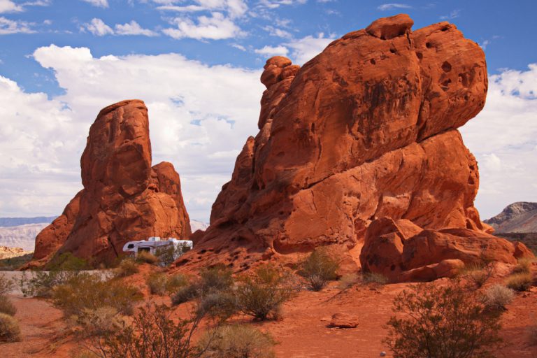 Large, red rock formations and RV in Valley of Fire State Park in Nevada.