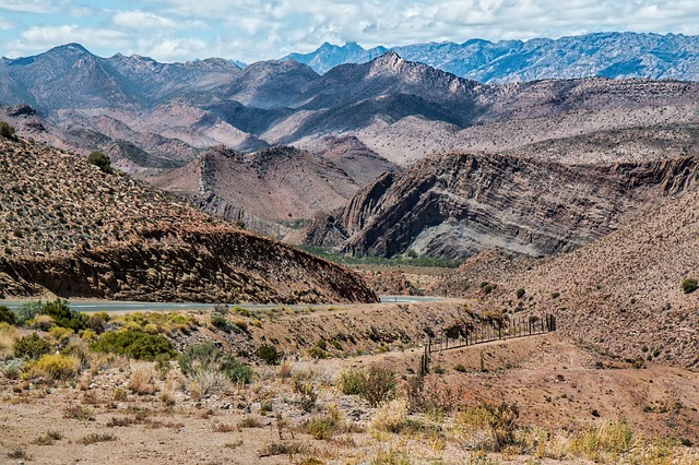 a sweeping view of red rocks and mountains