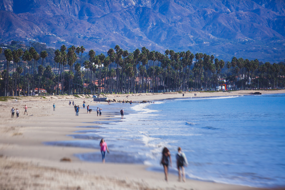 Beautiful view of Santa Barbara ocean front walk, with beach and marina, palms and mountains, Santa Ynez mountains and Pacific Ocean, Santa Barbara county, California, United States, summer sunny day