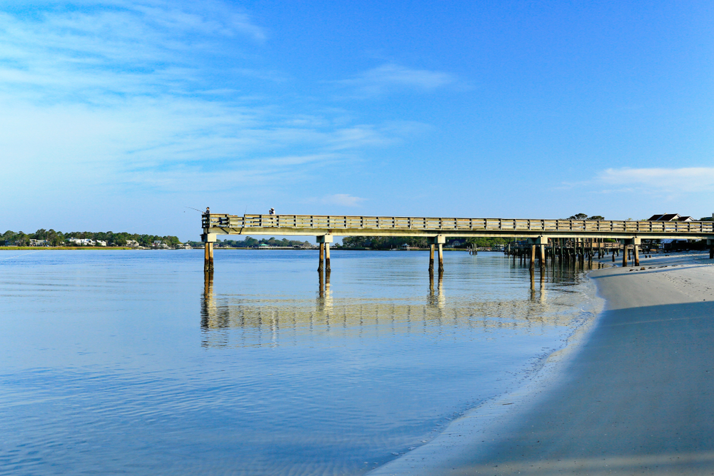 Early morning at the south end of Tybee Island beach. A view of the Tybee Creek side of the island and the Back River Fishing Pier