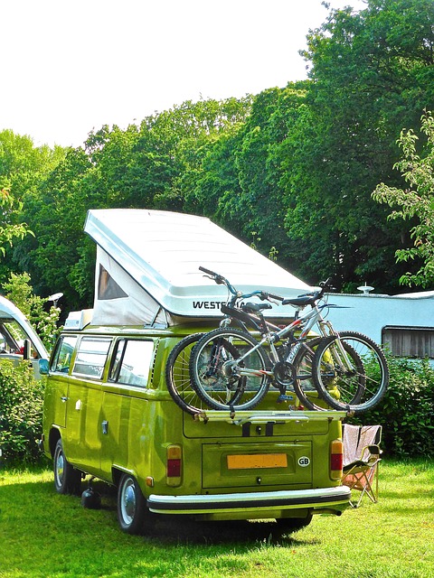 a campervan with bikes on the back set up for the night