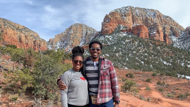 Couple and their dog poses in a desert