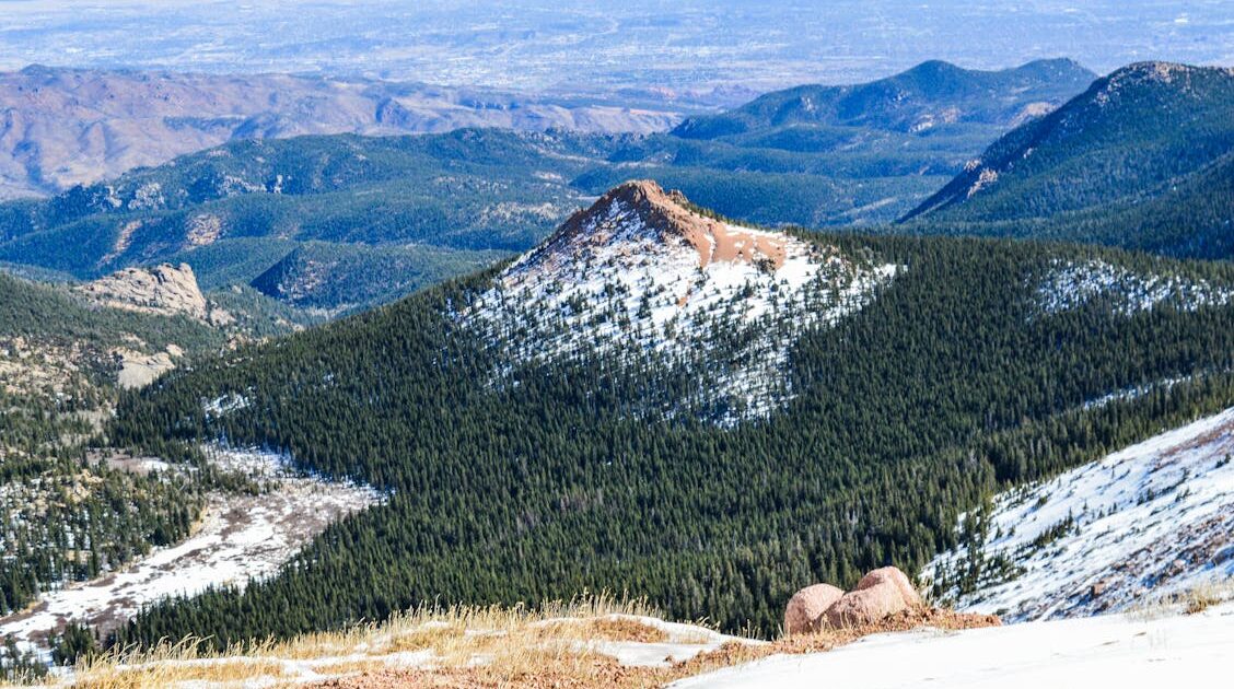 Snow-capped mountains rise above the valley floor in El Paso County, Colorado