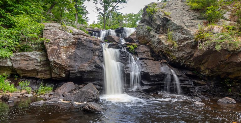 Landscape with waterfall, rocks and leafy green trees at Eightmile River , Chapman Falls, East Haddam, Connecticut Devil's Hopyard State Park