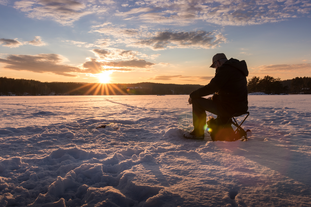 ice fishing is a fun activity while trying to view northern lights in Alaska