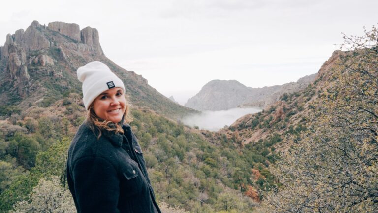 woman standing in front of mountains
