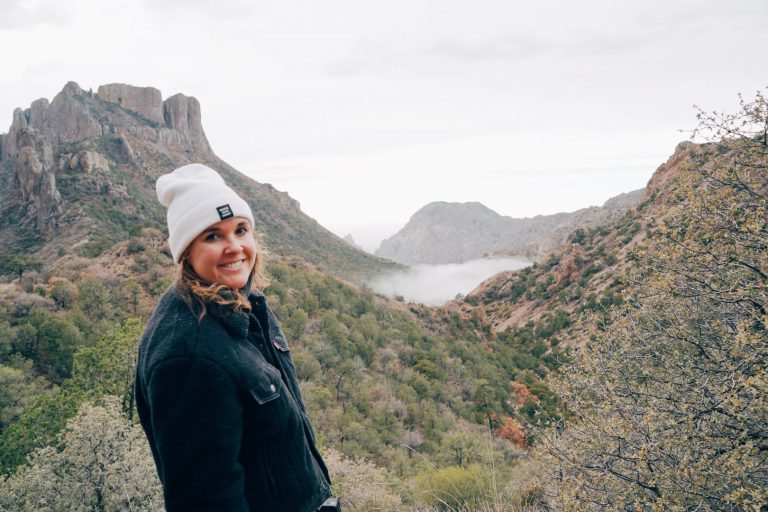 woman standing in front of mountains