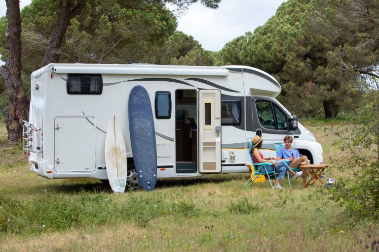 a camper with surfboard