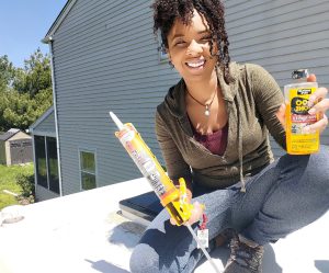 woman on rv roof with supplies