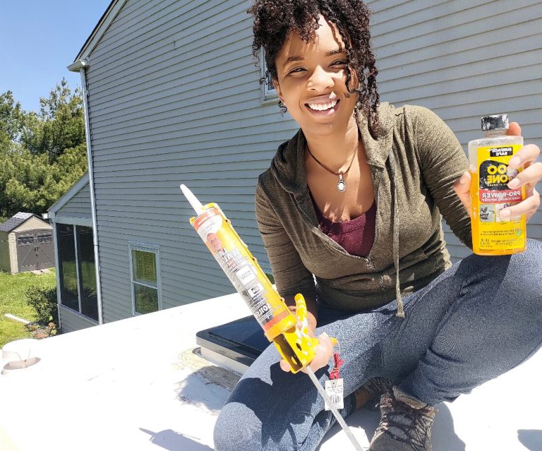 woman on rv roof with supplies