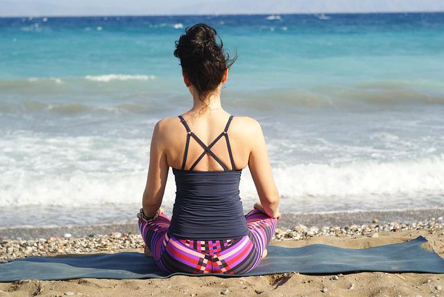 a woman on the beach doing yoga