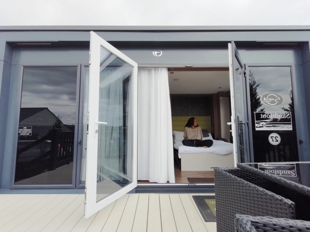 girl sitting on a bed in a tiny house