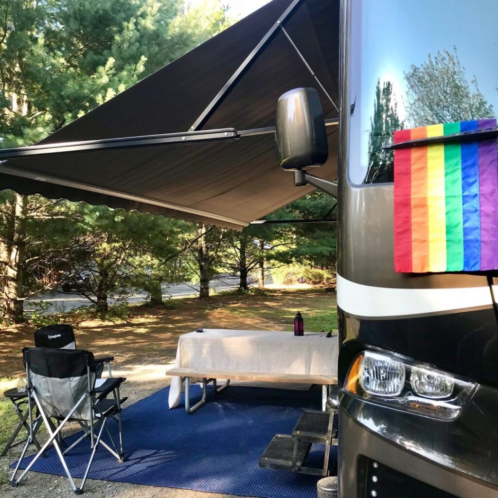 pride flag hangs outside a class a rv