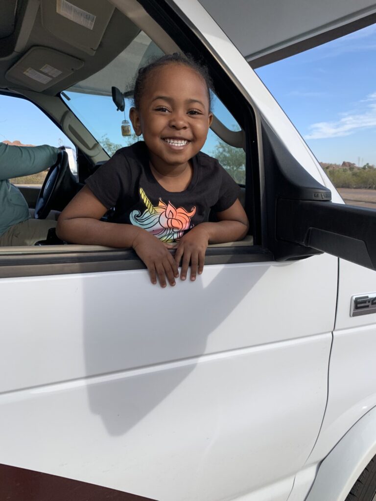 little kid peeking out passenger window