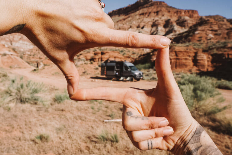 RV in the distance framed by fingers