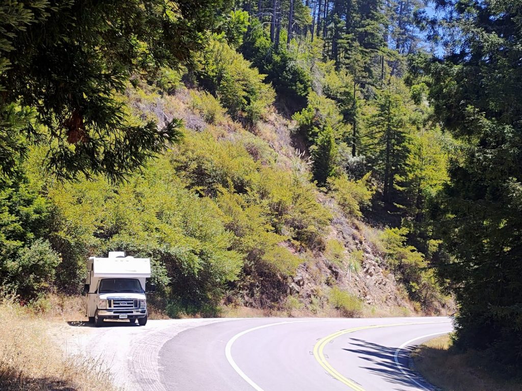 Class C RV parked on the road in the mountains