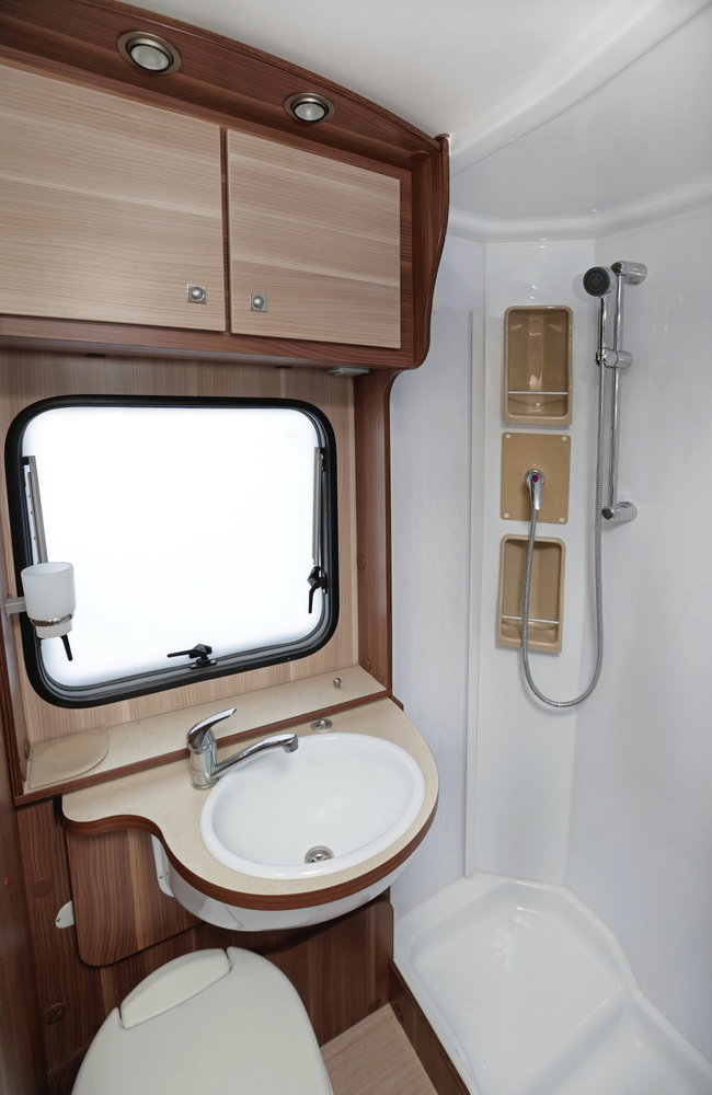 An RV shower with a sink and window