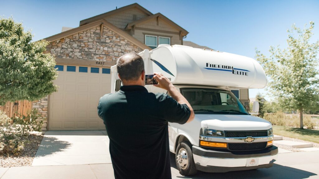 man taking a photo of an rv