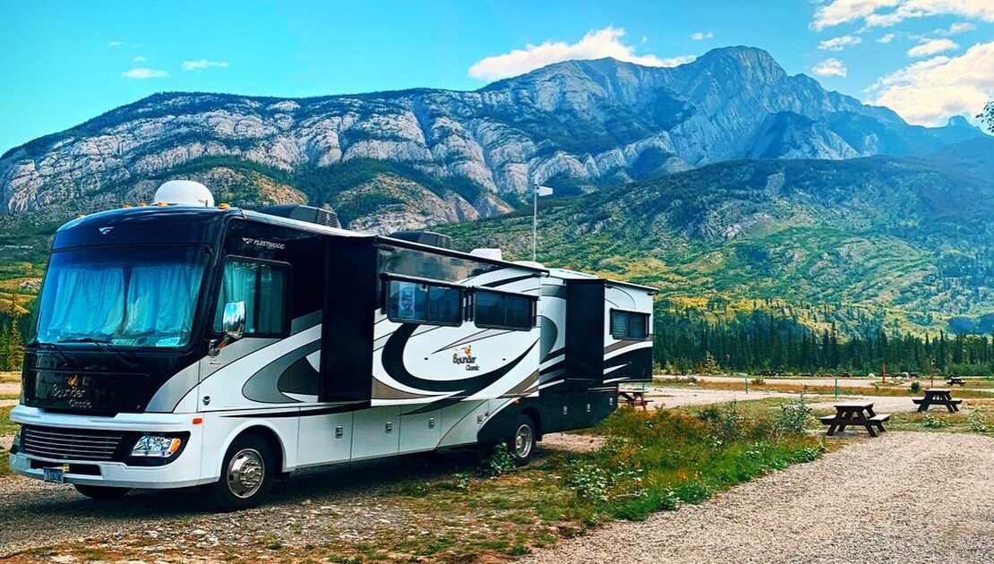 A motorhome parked in front of mountains