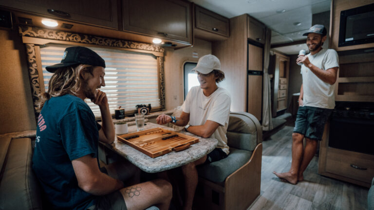 people sitting at a table inside an rv