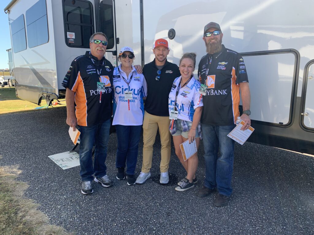 group standing in front of an rv