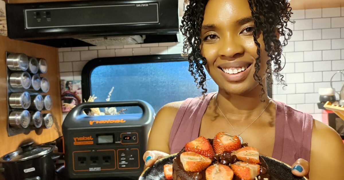 Woman holds Homemade brownie topped with strawberries