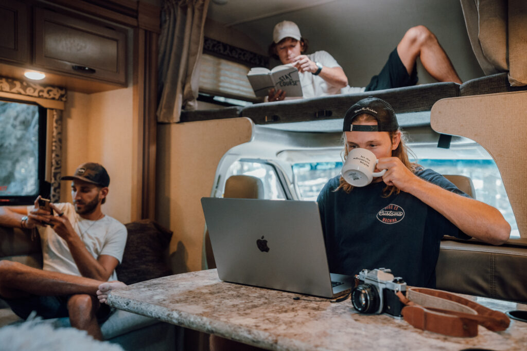 three men inside an rv