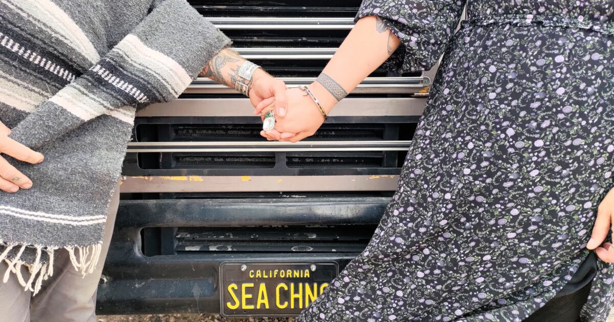 couple holding hands in front of RV