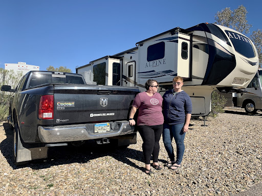 couple outside their fifth wheel