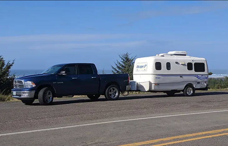 Truck pulling Escape 17B trailer with ocean in the background