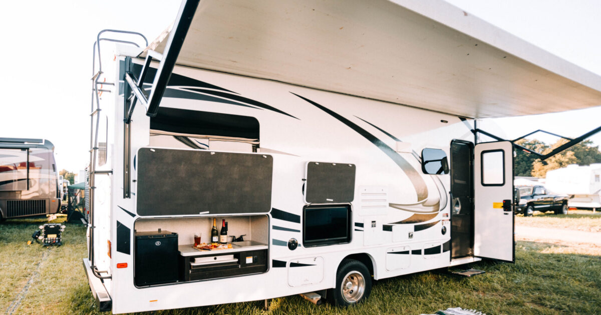 rv set up with awning and outdoor kitchen