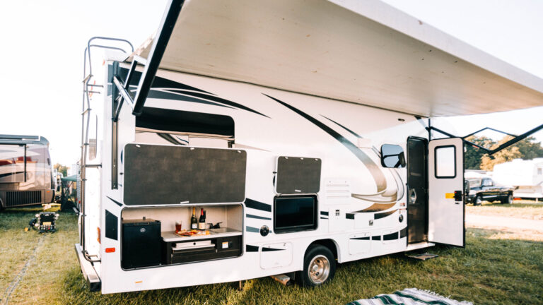 rv set up with awning and outdoor kitchen