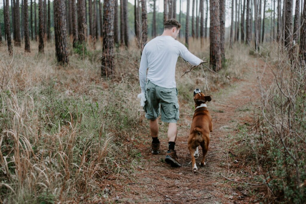 Man taking his dog camping and hiking