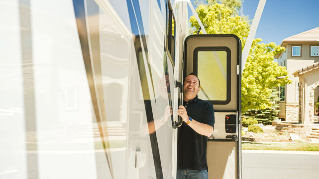 A man in an RV moochdocking in a driveway