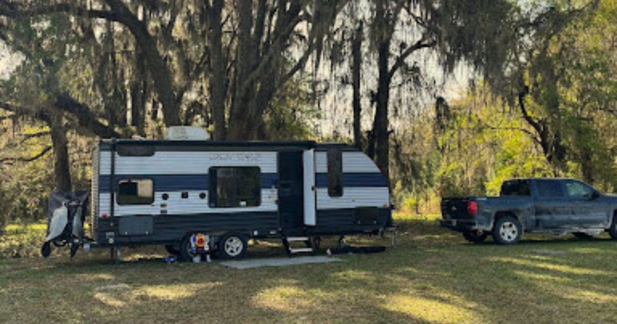 travel trailer set up in camp