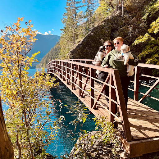 two queer women with dogs on a hiking trail