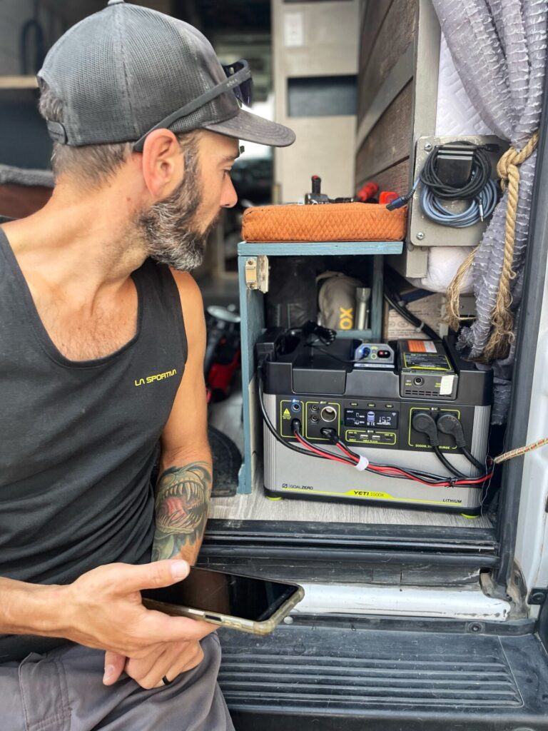 man working in electrical system of campervan