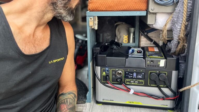 man working in electrical system of campervan