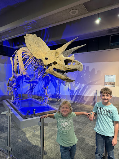 two kids standing in front of museum exhibit