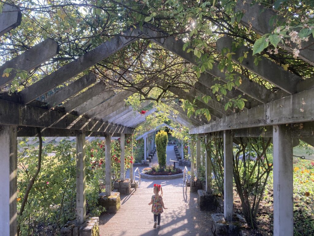 Girl enjoying the rose garden at Stanley Park