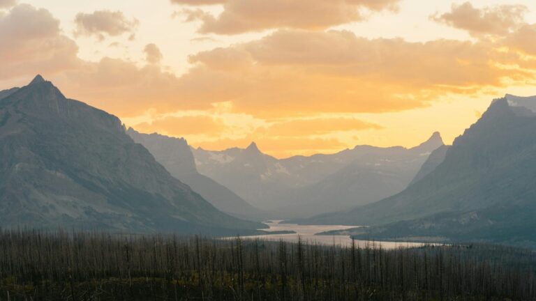 Silhouette of mountains under a golden sky.