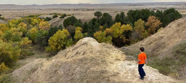 Small boy climbing rocks near one of many RV fall camping destinations